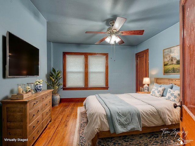 bedroom with light hardwood / wood-style flooring and ceiling fan