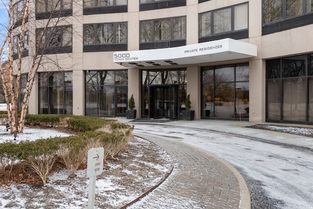 view of snow covered property entrance