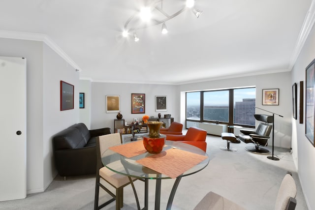 dining space with light carpet, radiator heating unit, ornamental molding, and rail lighting