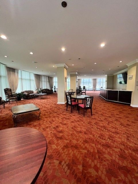 dining space with crown molding and carpet flooring