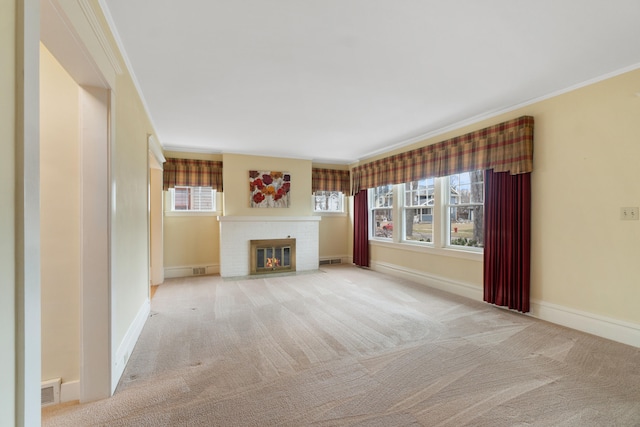 unfurnished living room with crown molding, light colored carpet, and a fireplace