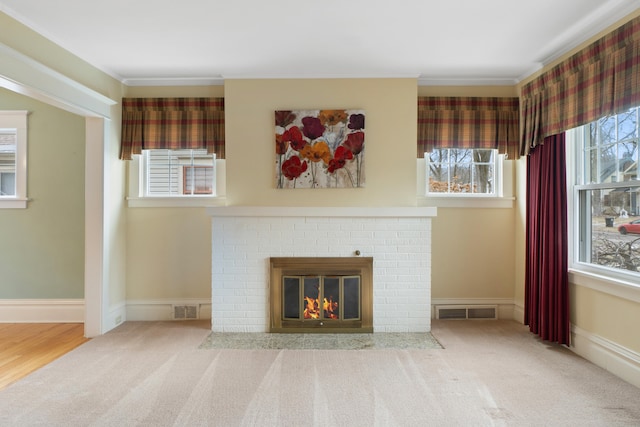 unfurnished living room featuring crown molding, a fireplace, and carpet flooring