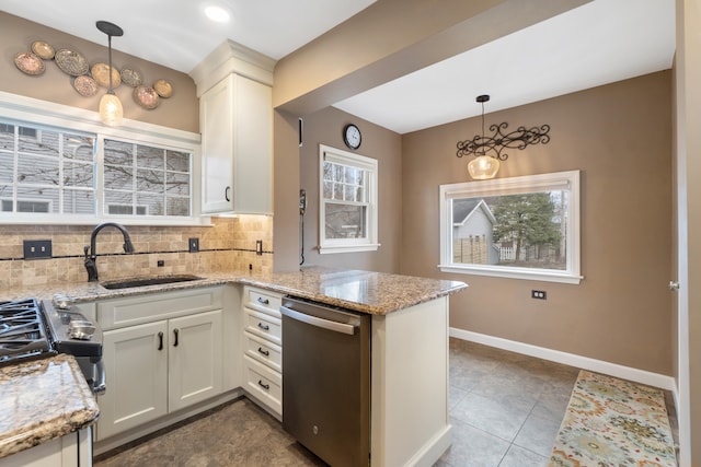 kitchen with dishwasher, sink, white cabinets, and decorative light fixtures