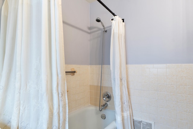 bathroom with shower / bath combo with shower curtain