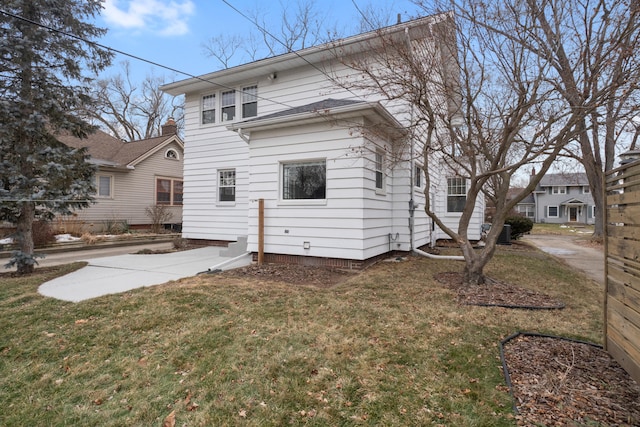 back of house featuring a yard