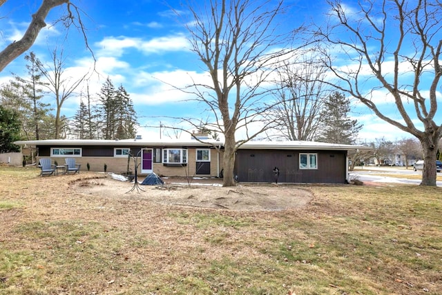 back of house with a lawn