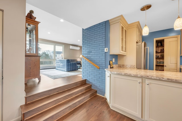 interior space featuring hardwood / wood-style floors and a wall unit AC