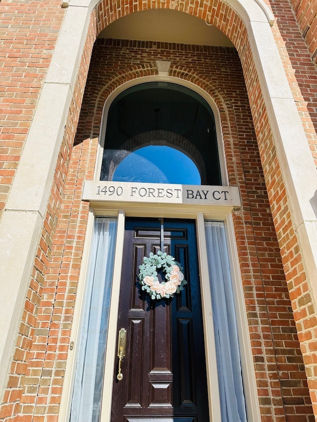 property entrance with brick siding