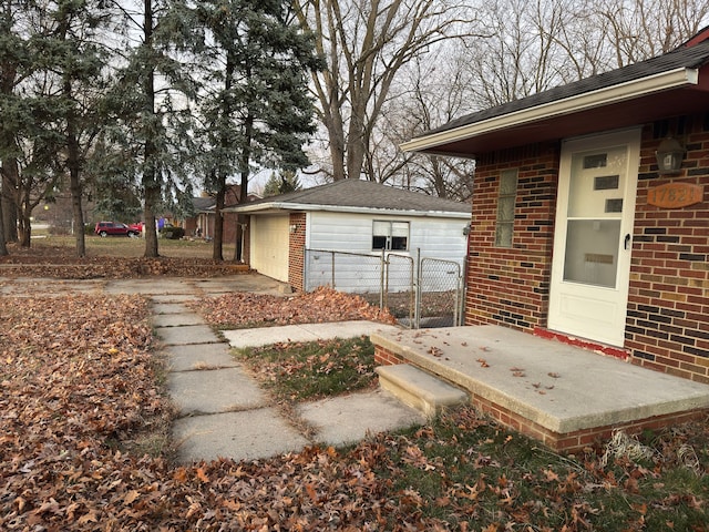 view of patio / terrace with a garage and an outdoor structure