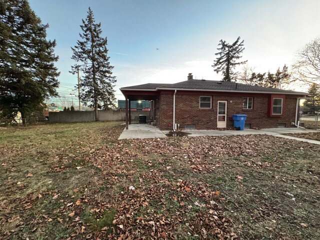 back of property featuring a yard and a patio