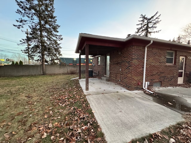 view of property exterior featuring a yard, cooling unit, and a patio area