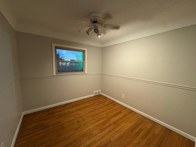 unfurnished room featuring hardwood / wood-style flooring, a textured ceiling, and ceiling fan