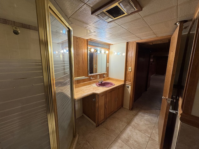 bathroom with vanity, an enclosed shower, and tile patterned floors