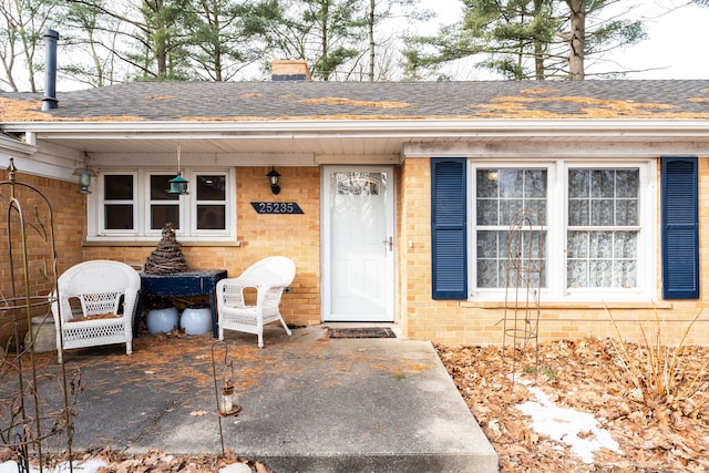 view of exterior entry with a patio area