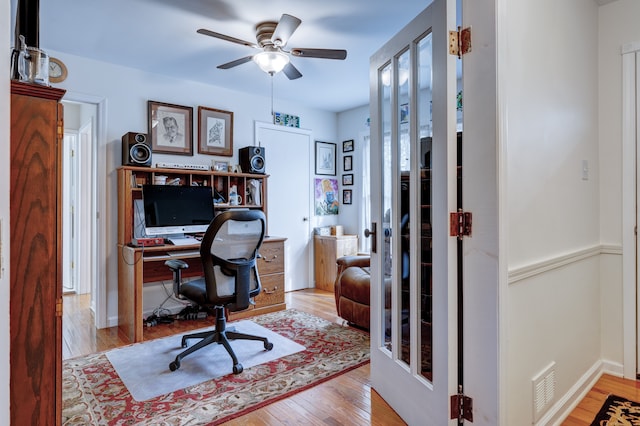 office area with ceiling fan and light hardwood / wood-style flooring