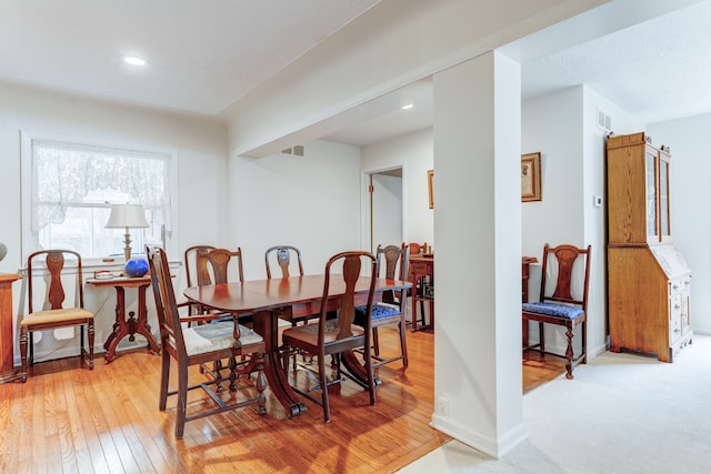 dining space with light hardwood / wood-style floors