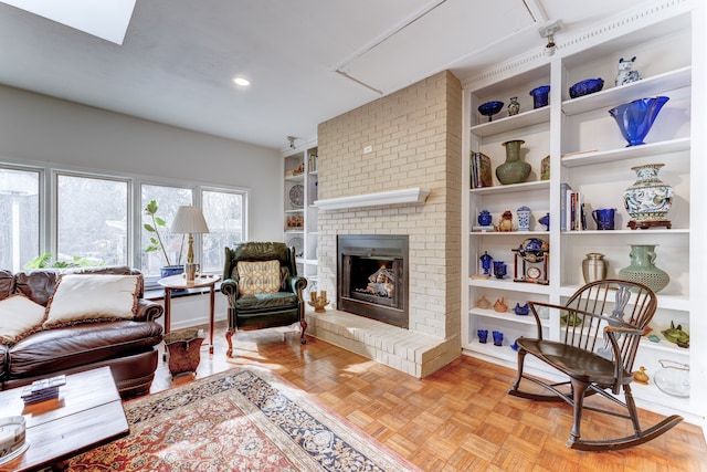 living room featuring light parquet flooring, built in features, and a fireplace