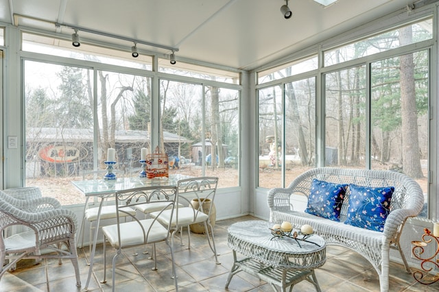 sunroom featuring track lighting