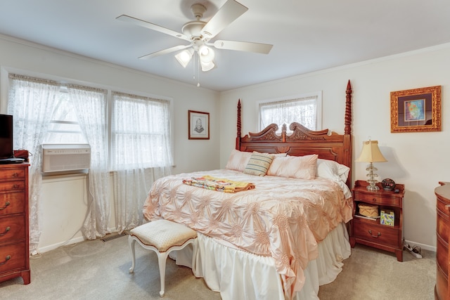 bedroom with crown molding, light colored carpet, and ceiling fan