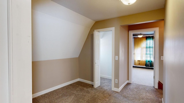 additional living space with carpet floors and vaulted ceiling