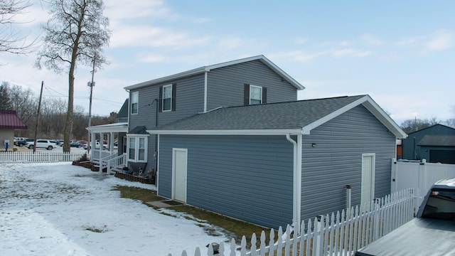 view of snowy exterior featuring a porch