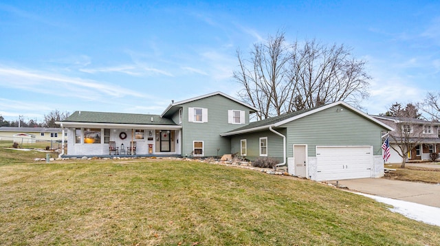 view of front of property featuring a porch, a garage, and a front lawn