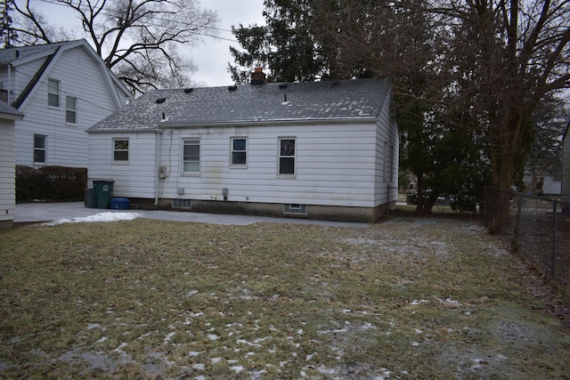 rear view of property with a lawn