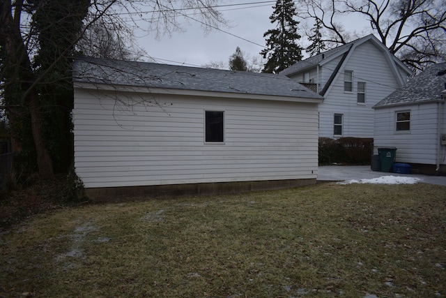 view of side of property with a lawn