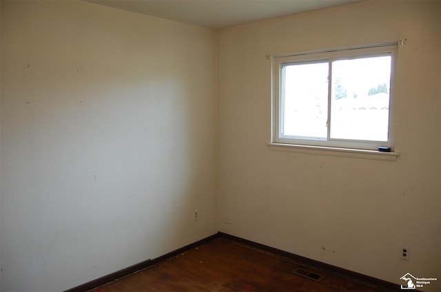 unfurnished room featuring dark hardwood / wood-style flooring