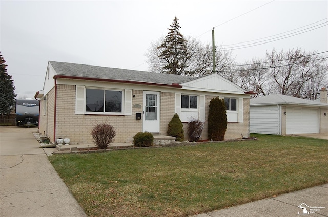 view of front of property featuring an outbuilding, a garage, and a front lawn