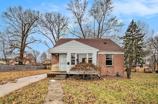 bungalow-style home with a front yard