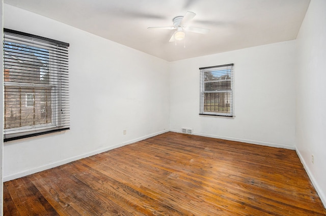 empty room with hardwood / wood-style flooring and ceiling fan