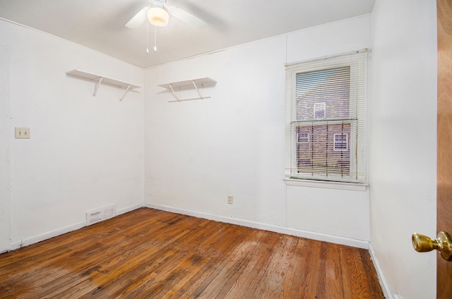 empty room with hardwood / wood-style flooring and ceiling fan