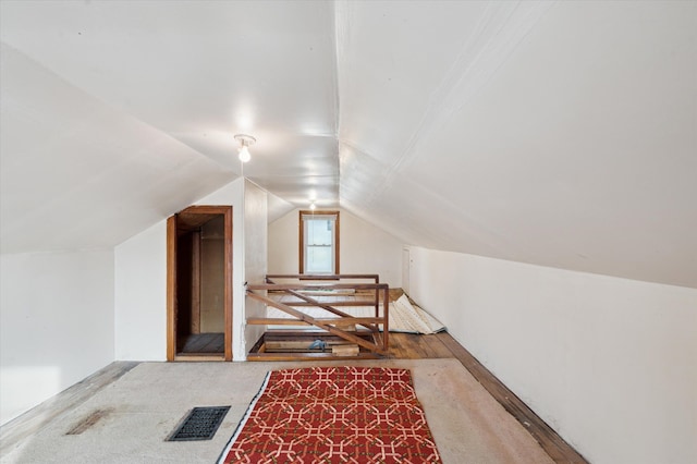 additional living space featuring lofted ceiling