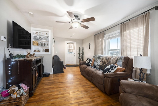 living room with hardwood / wood-style flooring and ceiling fan