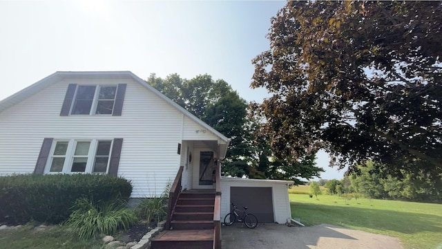 view of front of property featuring a garage and a front lawn