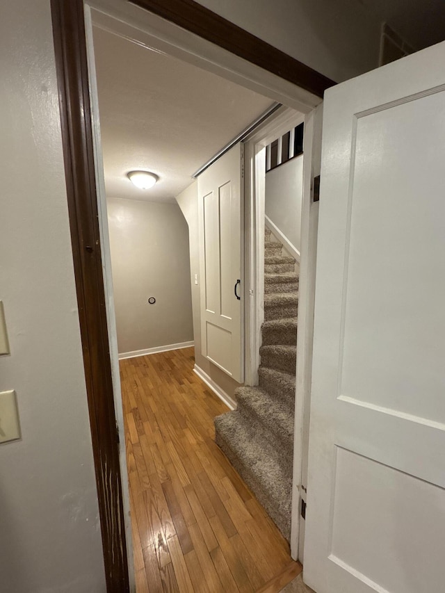 corridor with light hardwood / wood-style floors