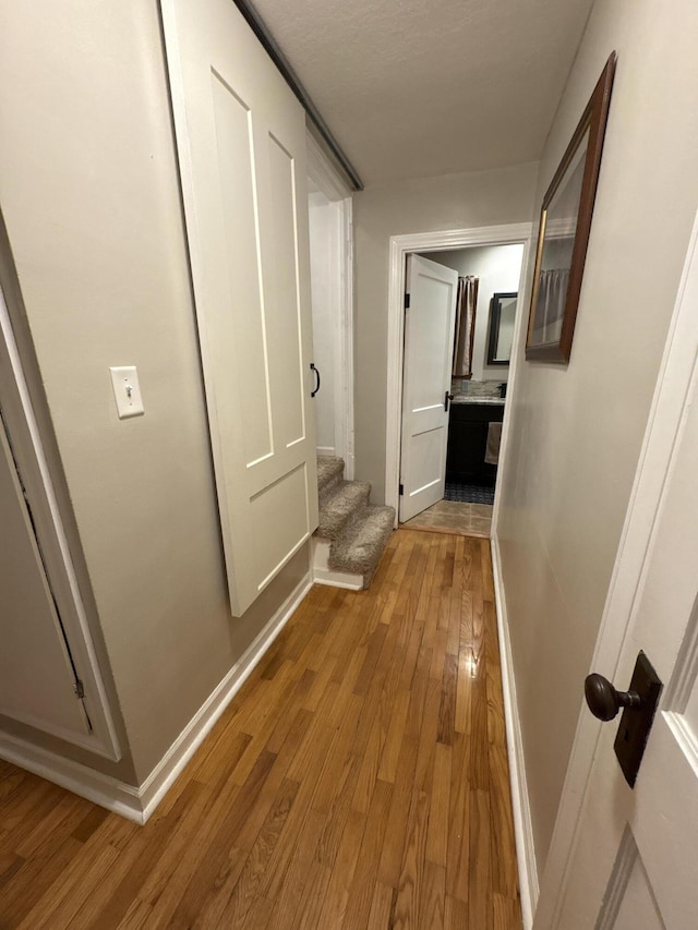 hallway with hardwood / wood-style floors