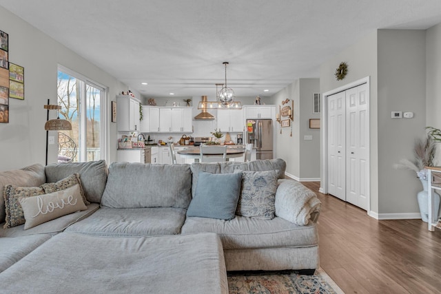 living room with wood-type flooring and a chandelier