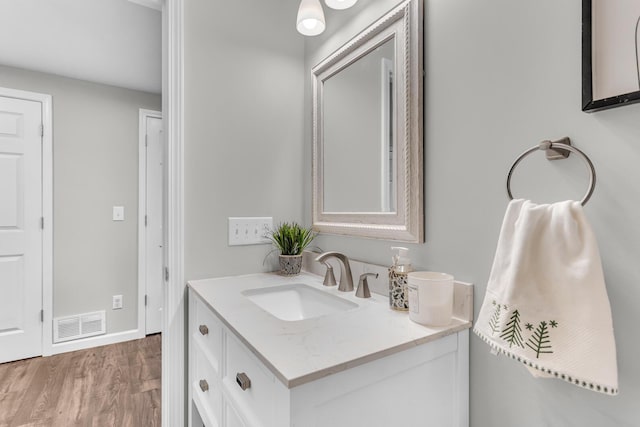 bathroom with vanity and hardwood / wood-style floors