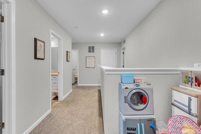 washroom with washer / dryer and light colored carpet