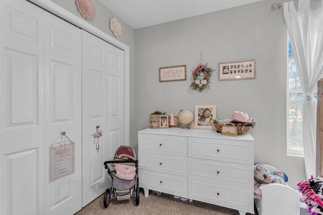 bedroom with light carpet and a closet