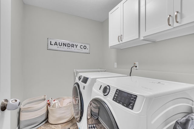 laundry room with cabinets and washing machine and dryer