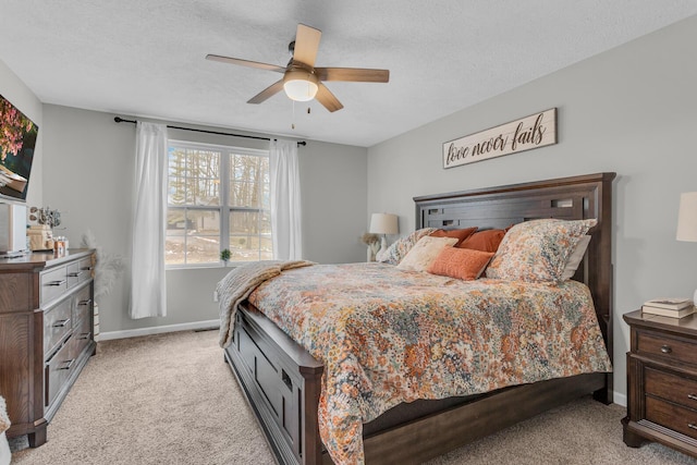 carpeted bedroom with ceiling fan and a textured ceiling