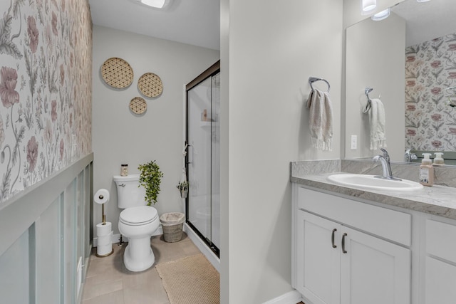 bathroom with tile patterned floors, vanity, toilet, and a shower with door