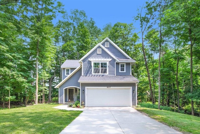 view of front of home featuring a garage and a front lawn