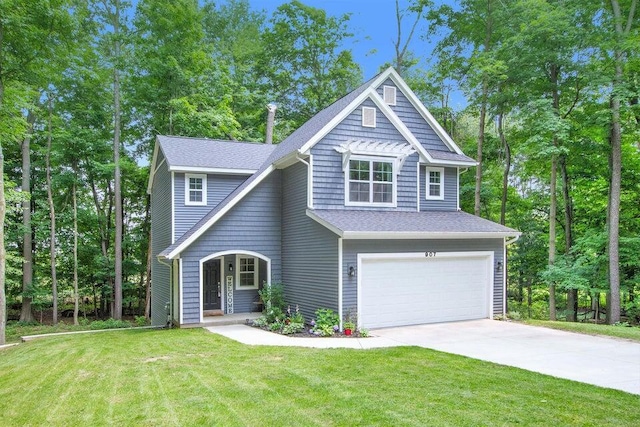 view of front of property featuring a garage and a front yard