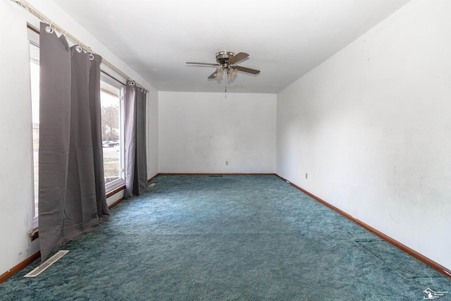 empty room featuring dark colored carpet and ceiling fan