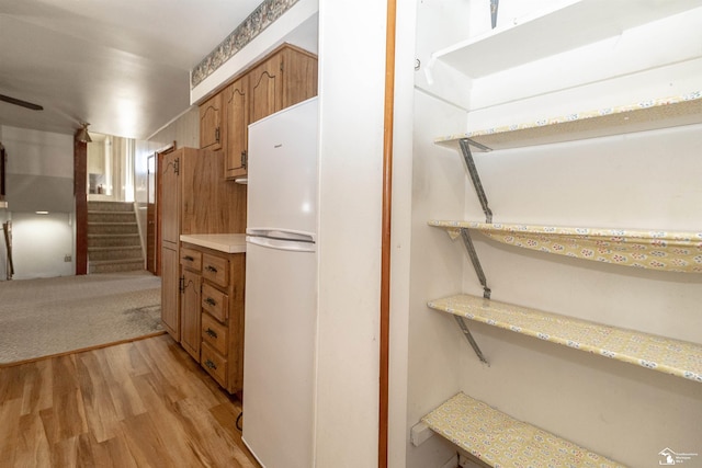 kitchen featuring light hardwood / wood-style floors and white refrigerator