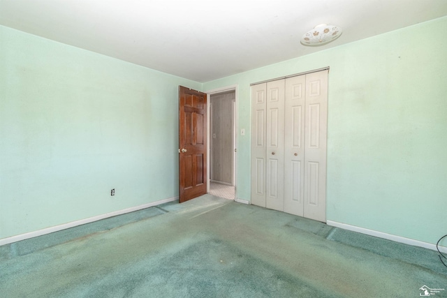 unfurnished bedroom featuring carpet flooring and a closet